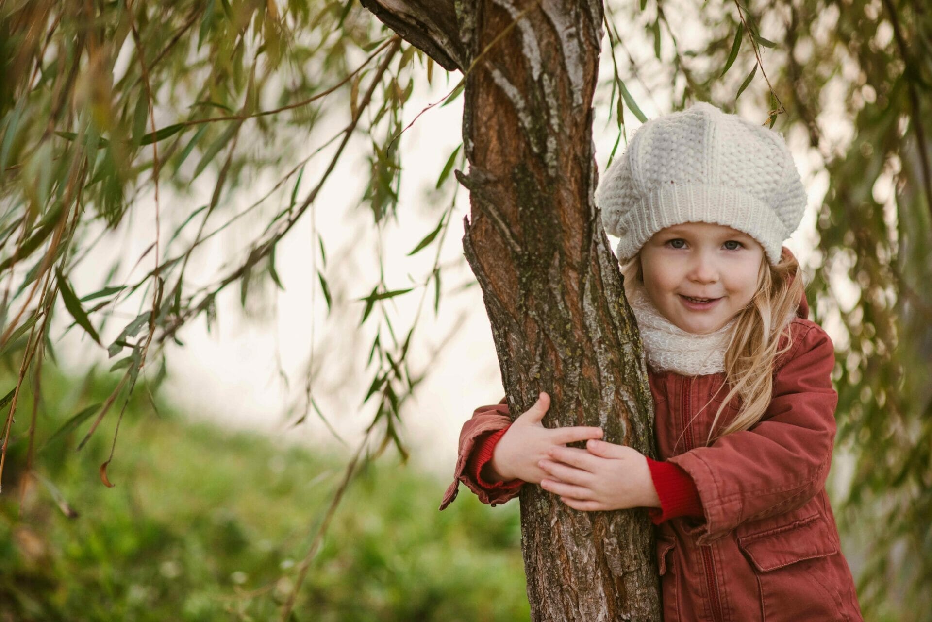 little girl is hugging a tree trunk 2022 11 10 19 19 37 utc