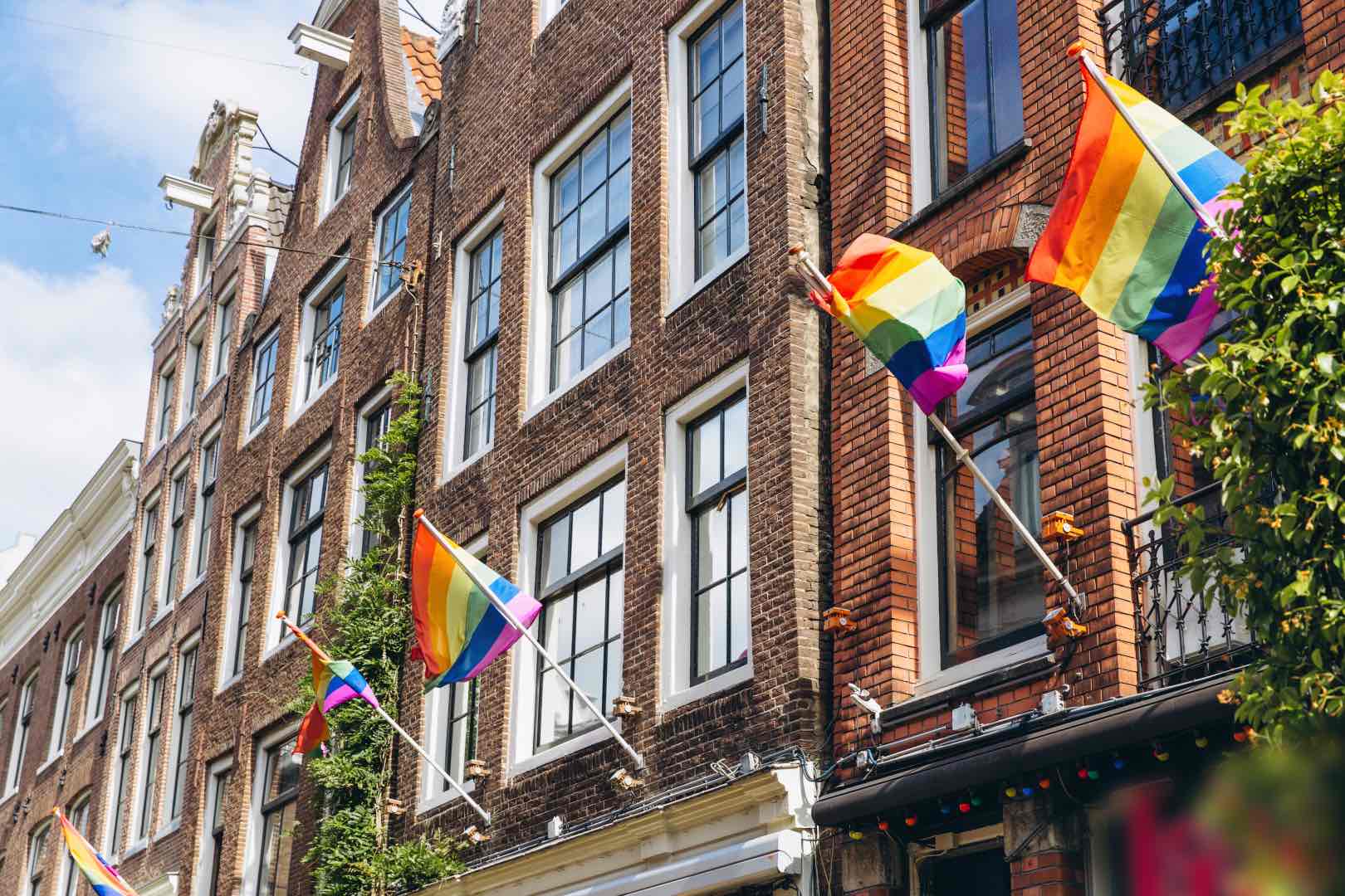 Gay flag in Amsterdam. Gay rainbow flag on a building. Rainbow flag of the LGBT community on the building on street Amsterdam.