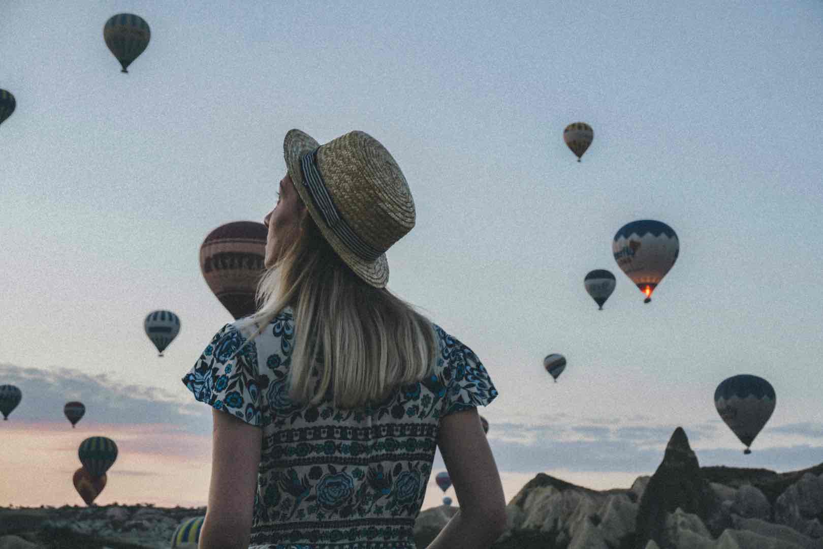 female looking at balloons