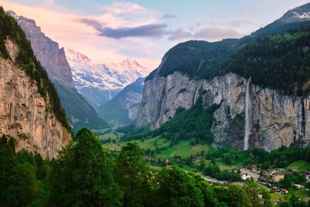 A panoramic view of the Swiss Alps with snow-capped peaks and Lauterbrunnen valley